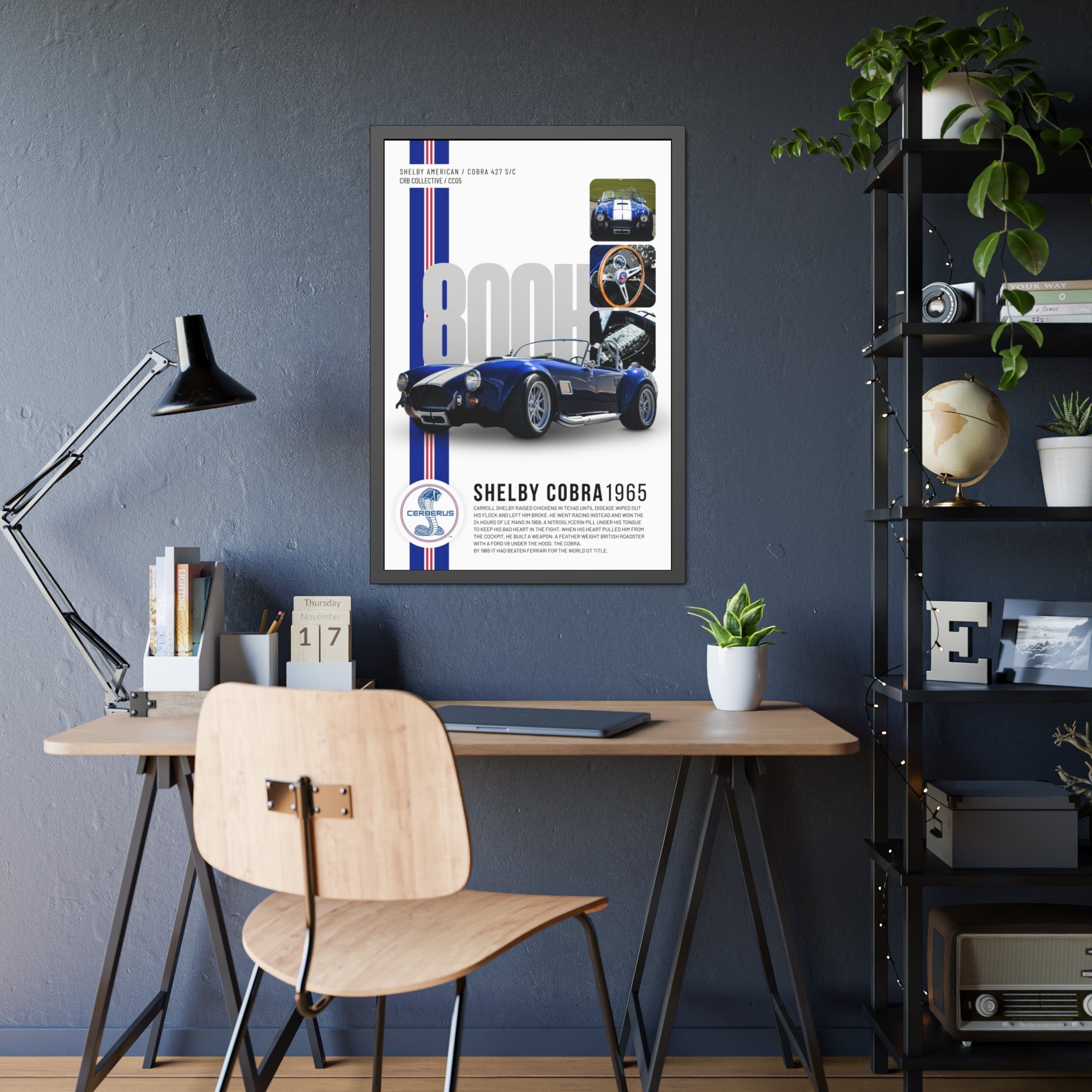 Framed Shelby Cobra 1965 poster on a wall above a desk with a chair.