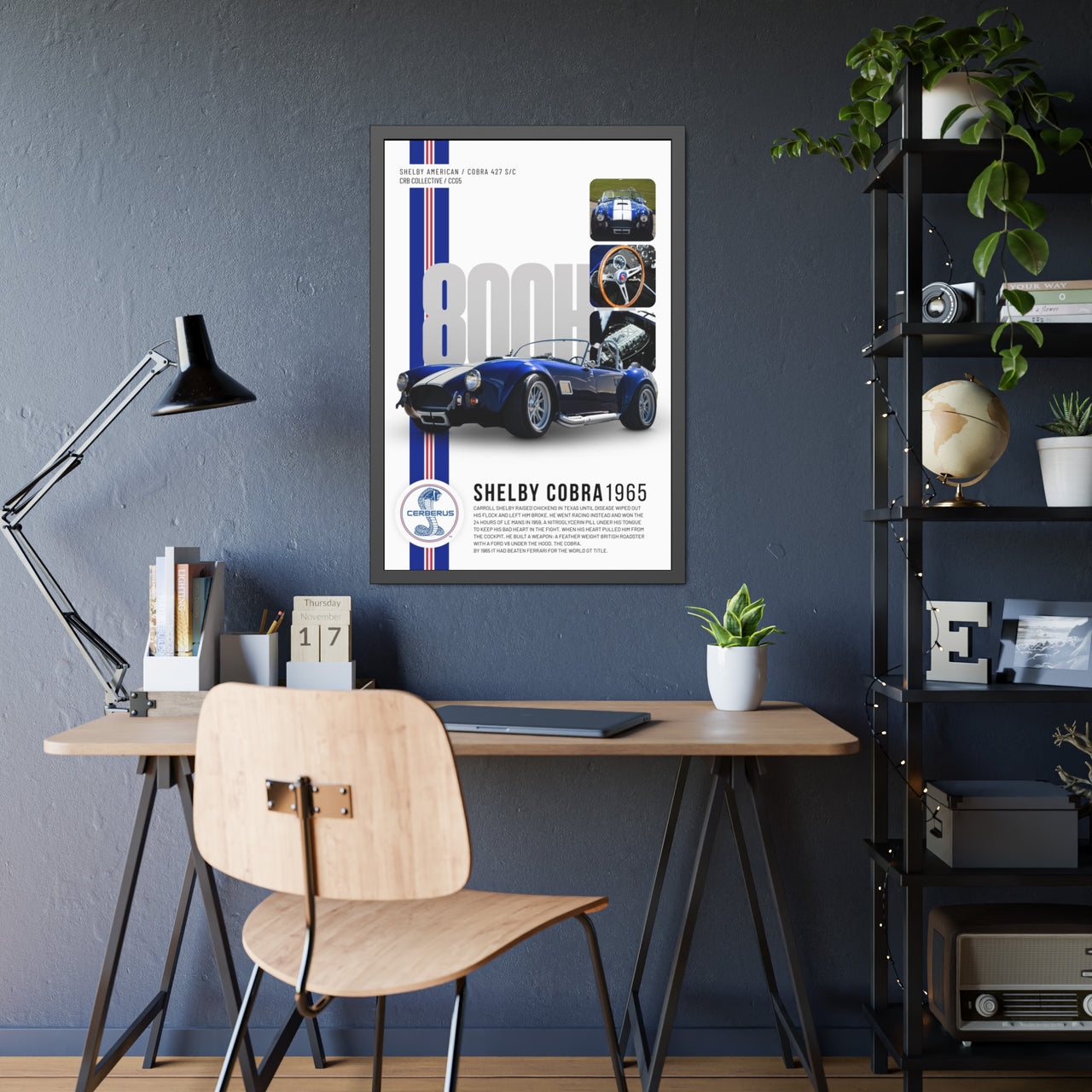 Framed Shelby Cobra 1965 poster on a wall above a desk with a chair.